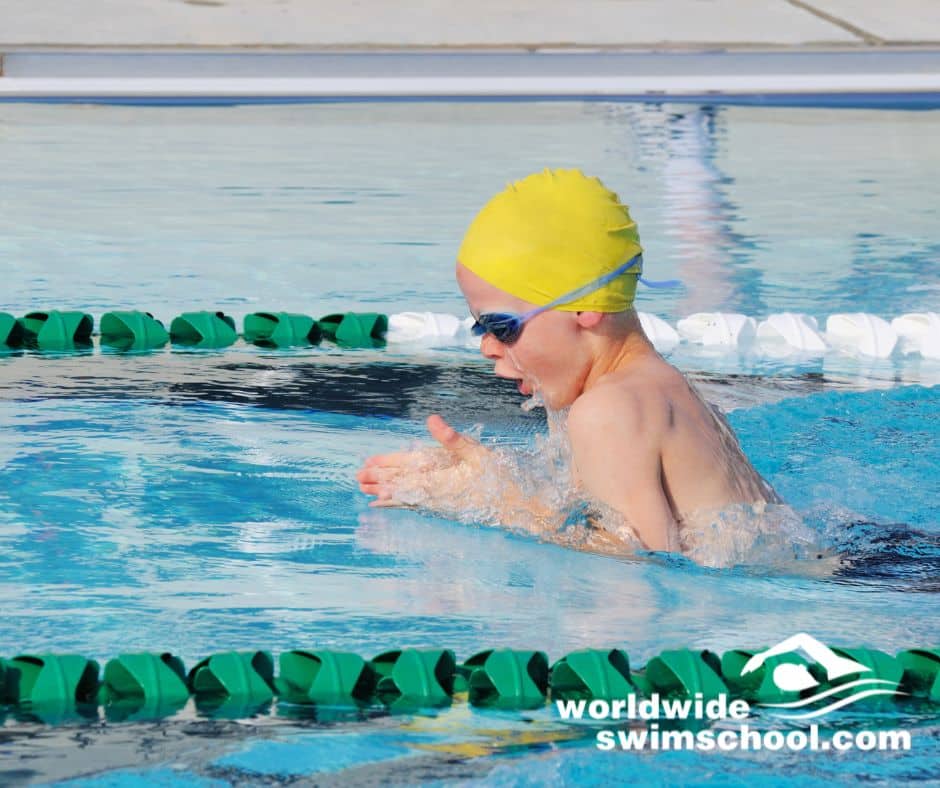 Child doing breaststroke in swimming pool