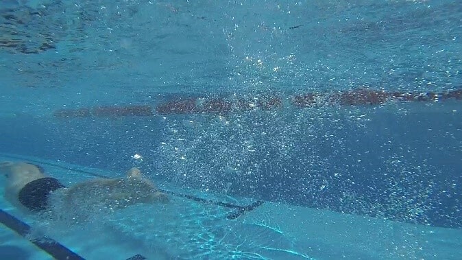 Tumble turn swimming away from end of pool 