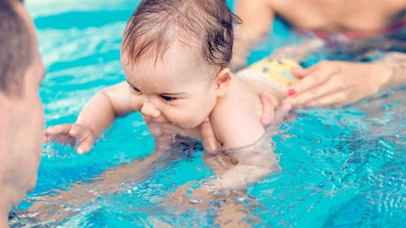 baby happy swimming in water