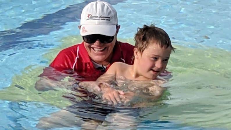 swimmer with coach in swimming pool